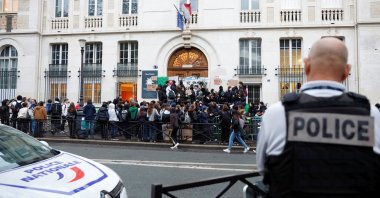French police stand guard as students block the entrance of the Lycee Montaigne high school to protest as part of a nationwide day of strike in Paris, France, Oct. 18, 2022. (Reuters Photo)