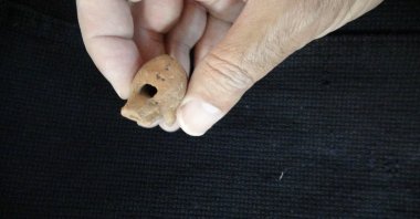 A 2,000-year-old whistle made of terracotta from the Roman period was found in a child&#039;s grave as a grave gift, Çanakkale, Türkiye, Oct. 18, 2022. (IHA Photo)