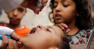 A boy receives polio vaccine drops in an outskirt of the capital Sanaa, Yemen, Aug. 11, 2014. (Reuters Photo)