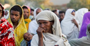 A woman stands in line to receive food donations at the Tsehaye primary school, which was turned into a temporary shelter for people displaced by conflict, Shire, Tigray, Ethiopia, March 15, 2021. (REUTERS Photo)