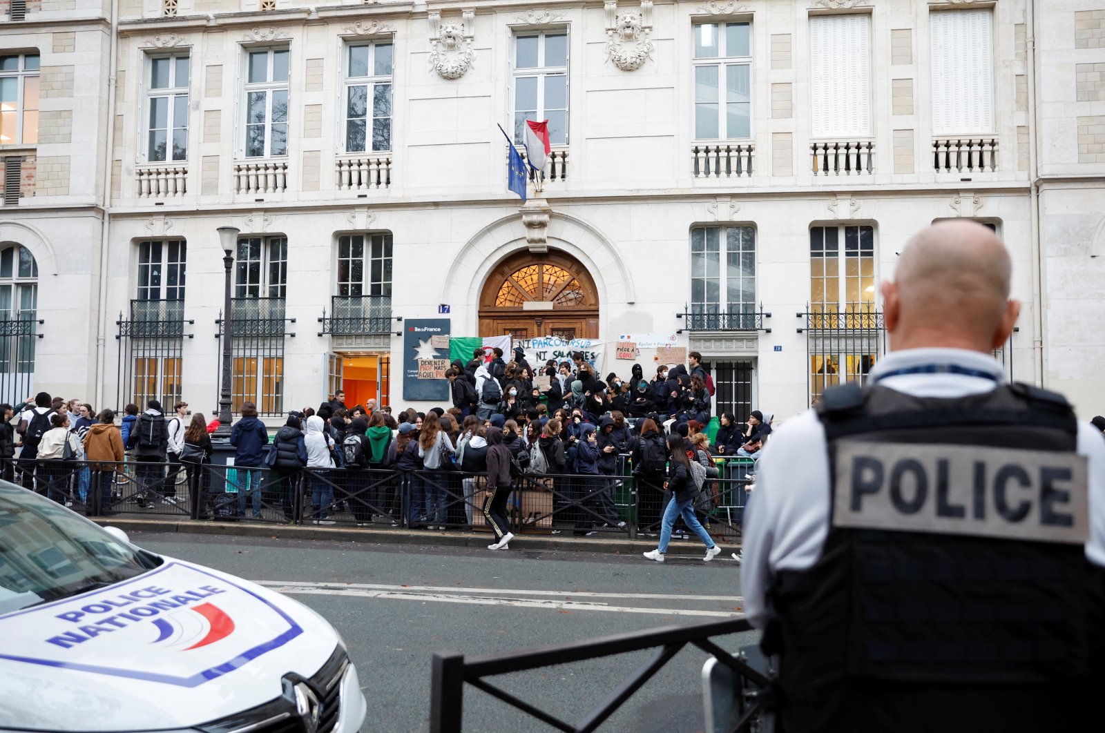 French police stand guard as students block the entrance of the Lycee Montaigne high school to protest as part of a nationwide day of strike in Paris, France, Oct. 18, 2022. (Reuters Photo)