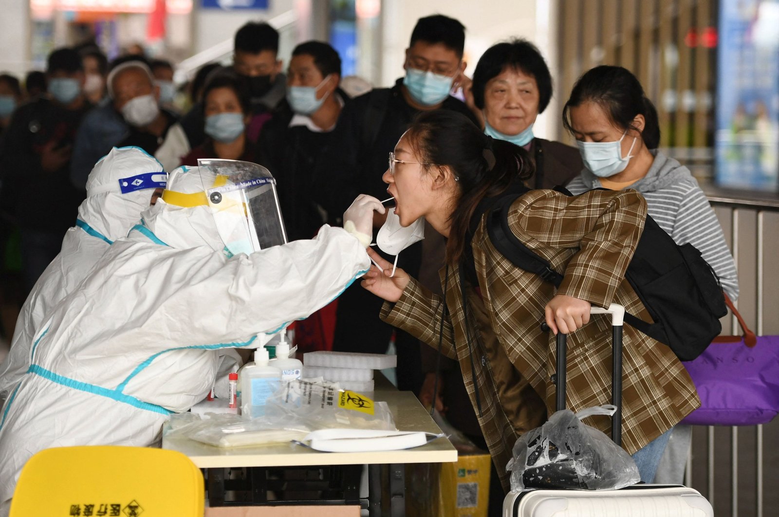 A passenger undergoes a nucleic acid test for COVID-19 as she arrives at the Nanjing Railway Station during National Day holidays in Nanjing, Jiangsu province, China, Oct. 6, 2022. (AFP Photo)