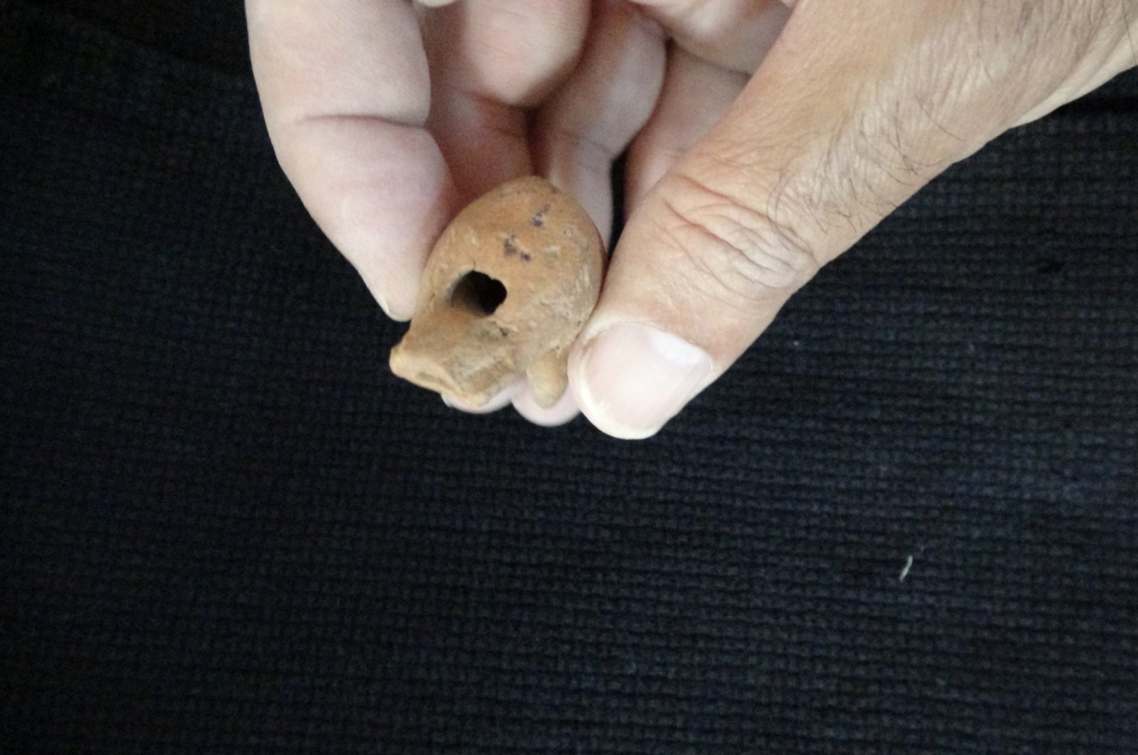 A 2,000-year-old whistle made of terracotta from the Roman period was found in a child&#039;s grave as a grave gift, Çanakkale, Türkiye, Oct. 18, 2022. (IHA Photo)