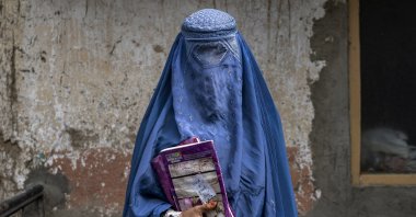 Forty-year-old Arefeh leaves an underground schoolin Kabul, Afghanistan, July 30, 2022. (AP Photo)