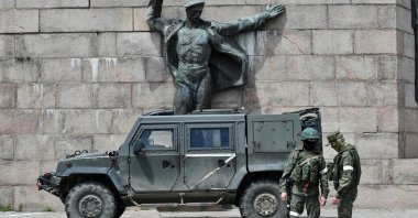 Russian servicemen patrol at the Eternal Flame monument, Kherson, Ukraine, May 20, 2022. (AFP Photo)