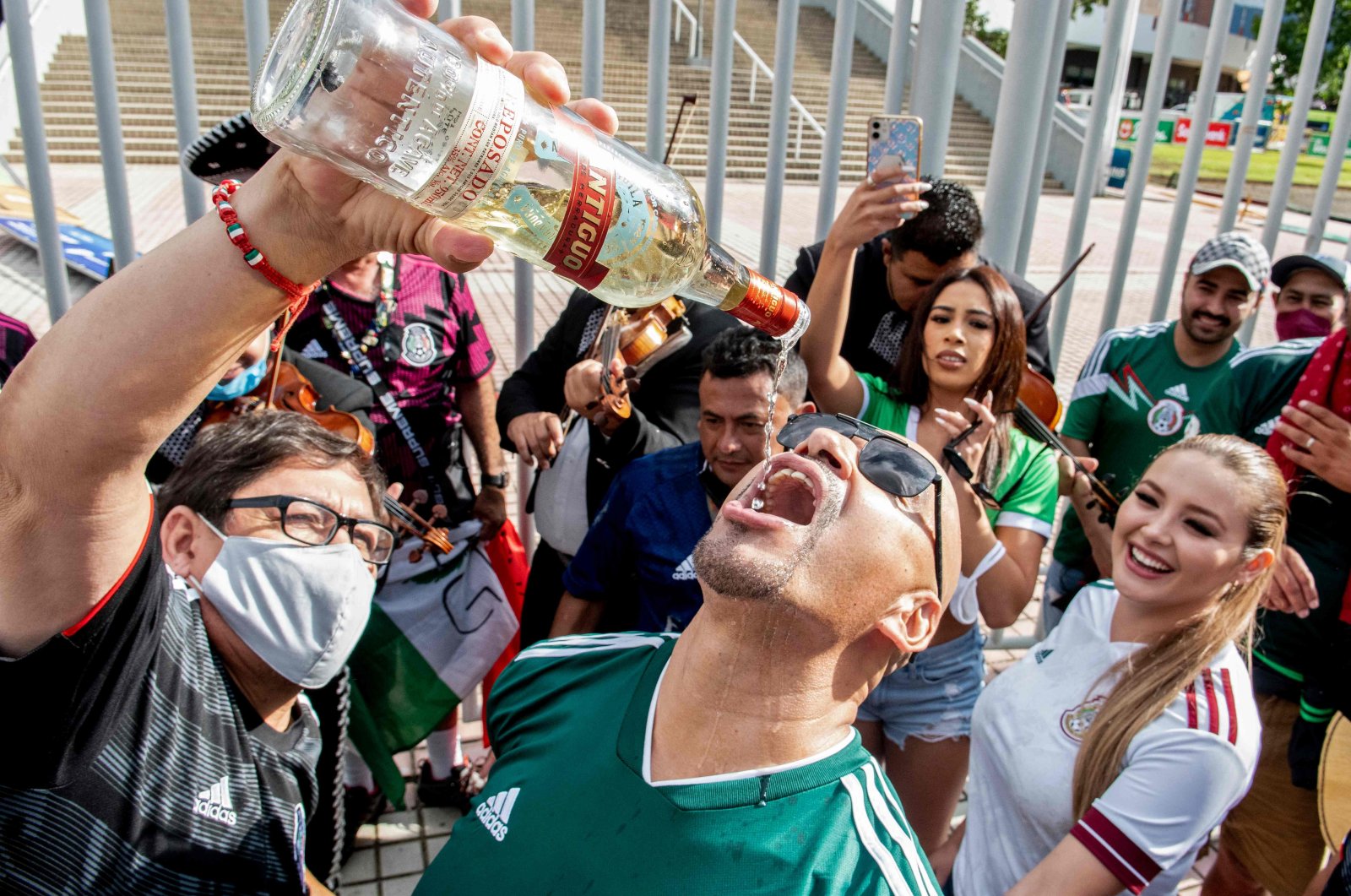 Mexican fans drink tequila outside the National Stadium before the Qatar 2022 FIFA World Cup qualifier match against Costa Rica, San Jose, Costa Rica, Sept. 5, 2021. (AFP Photo)