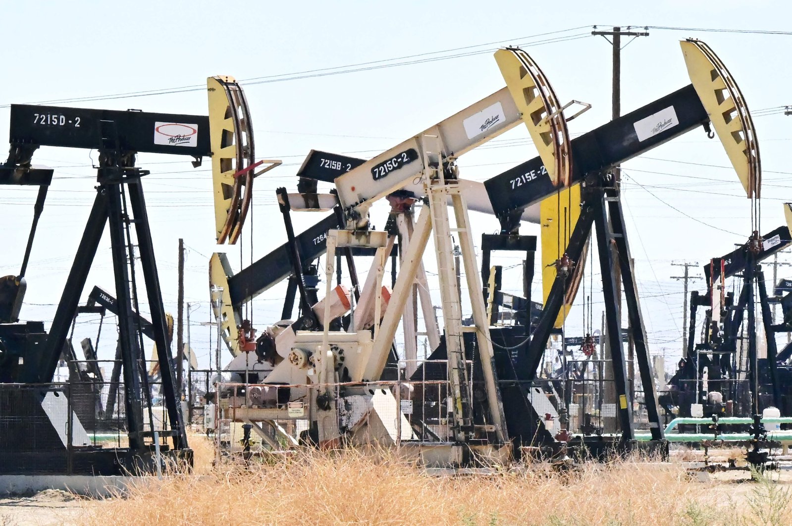 This picture taken on Sept. 28, 2022 shows oil pump jacks along a section of Highway 33 known as the Petroleum Highway north of McKittrick in Kern County, California. (Photo by Frederic J. BROWN / AFP)