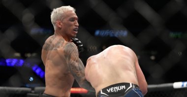 Brazil&#039;s Charles Oliveira punches Justin Gaethje in the UFC lightweight championship fight during the UFC 274 event at Footprint Center, Phoenix, Arizona, May 7, 2022. (Getty Photo)