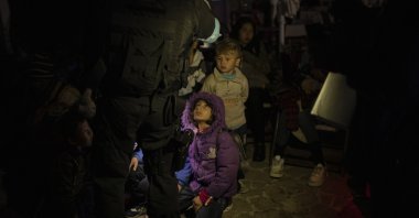 A Frontex coast guard counts migrants and refugees in the tiny harbor of Skala Sikamias, in Lesbos island, on Oct. 3, 2019. (AP Photo)