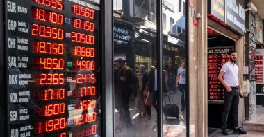 A man stands next to an exchange office in Istanbul, Türkiye, Sept. 23, 2022. (EPA Photo)