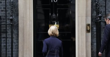 Liz Truss, followed by her husband Hugh O'Leary (R), walks back into 10 Downing Street after making a statement where she announced her resignation as Prime Minister, in London, Britain, Oct. 20, 2022. (AP Photo)