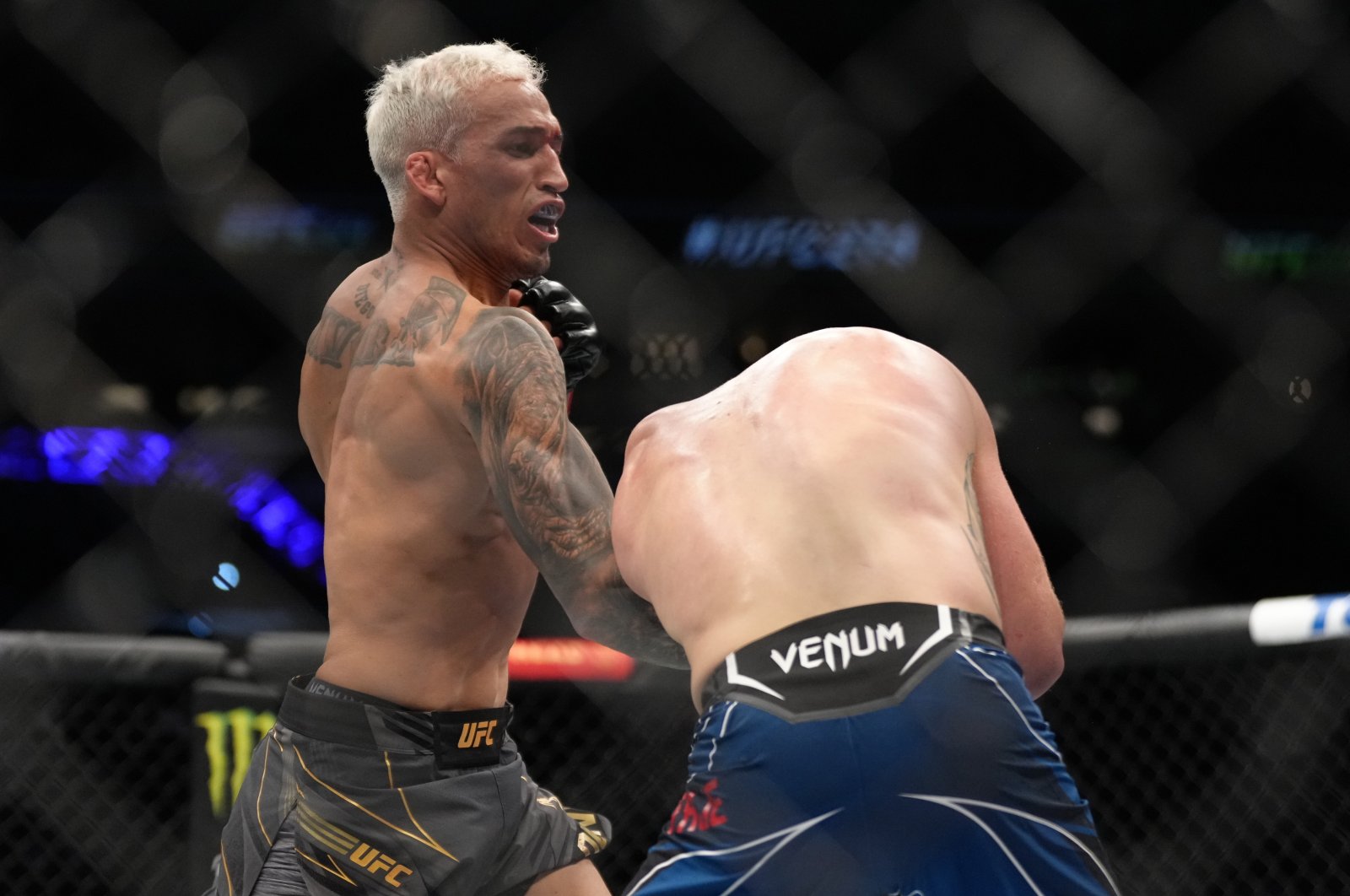 Brazil&#039;s Charles Oliveira punches Justin Gaethje in the UFC lightweight championship fight during the UFC 274 event at Footprint Center, Phoenix, Arizona, May 7, 2022. (Getty Photo)