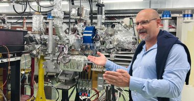 CLEAR Lab facility coordinator Roberto Corsini gestures next to a linear particle accelerator at CERN, in Meyrin, near Geneva, Switzerland, Oct. 17, 2022. (AFP Photo)