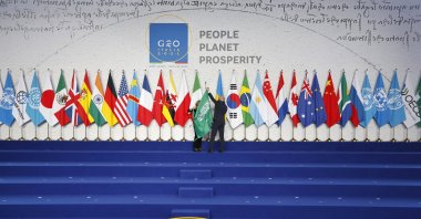 Employees arrange the Saudi Arabian flag during the final preparations before world leaders gather for the official family photograph on day one of the G-20 Summit at the convention center of La Nuvola, in Rome, Italy, Oct. 30, 2021. (Reuters Photo)