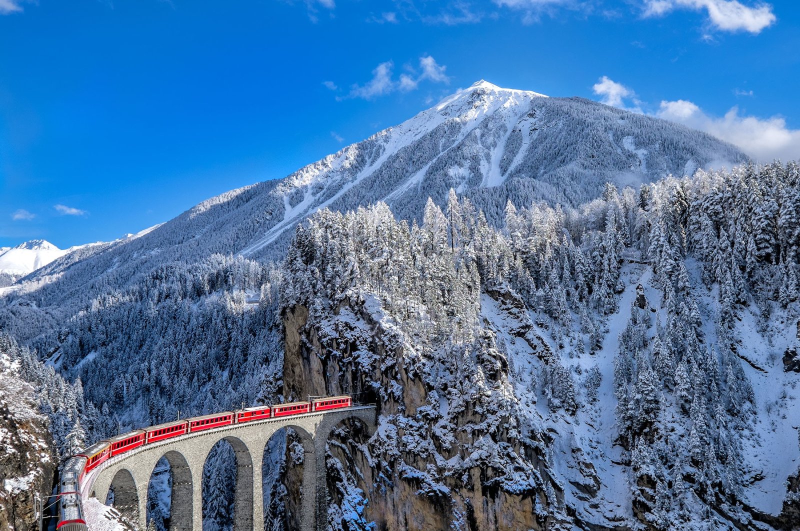 The Glacier Express is an express train in the central Swiss Alps that connects the two major mountain resorts of Zermatt and St. Moritz in Switzerland. (Shutterstock Photo)