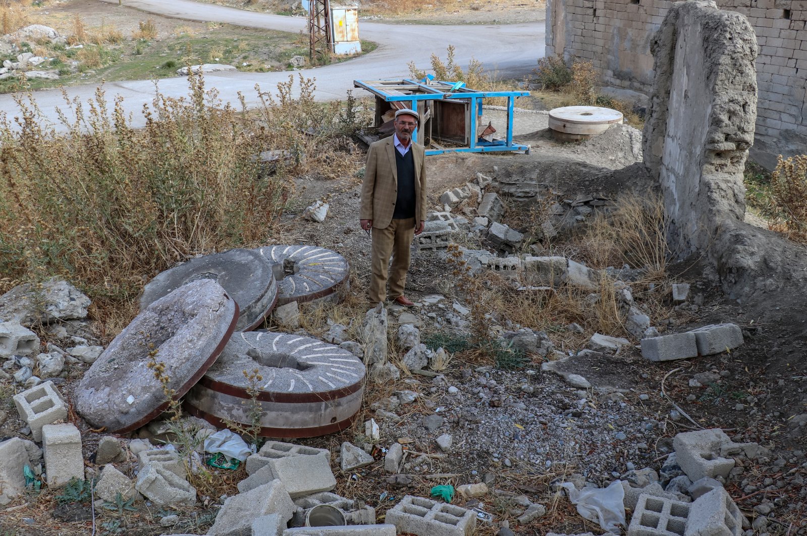 Earthquake survivor Ferzende Zan stands amid ruins of the mill he used to work at, in Van, eastern Türkiye, Oct. 22, 2022. (AA Photo)