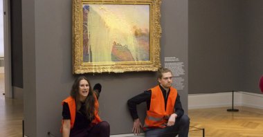 Climate protesters of Last Generation after throwing mashed potatoes at the Claude Monet painting &quot;Les Meules&quot; at Potsdam’s Barberini Museum, Germany, Oct. 24, 2022. (AP Photo)