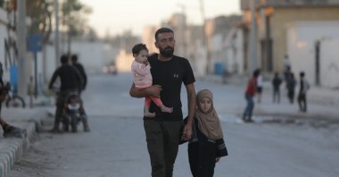 Rami Dahis and his children are seen in Tal Abyad, northern Syria, Oct. 24, 2022. (AA Photo)