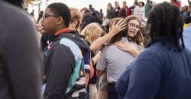 People gather outside after a shooting at Central Visual and Performing Arts high school in St. Louis, Missouri, U.S., Oct. 24, 2022. (AP Photo)