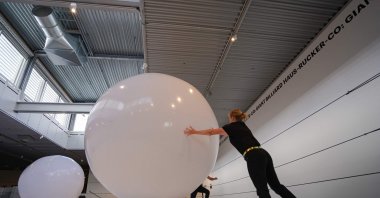 Visitors interact with the "Giant Billiard," an art installation by Austrian architect/artist group Haus-Rucker-Co, originally staged in 1970 and recreated at Arken Museum of Modern Art in Ishoj, near Copenhagen, Denmark, Oct. 8, 2022. (AFP Photo)