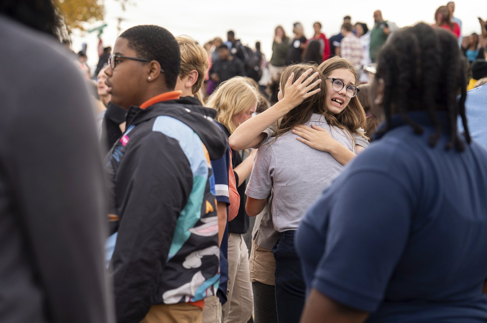 People gather outside after a shooting at Central Visual and Performing Arts high school in St. Louis, Missouri, U.S., Oct. 24, 2022. (AP Photo)