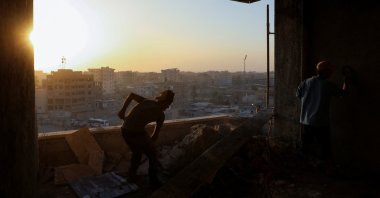 Construction workers labor inside a building in Raqqa, Syria, Oct. 13, 2022. (REUTERS Photo)