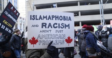 People with posters rejecting racism and Islamophobia during a rally in Toronto, Canada, Feb. 4, 2017.