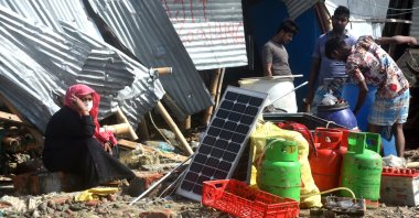 People salvage belongings in the aftermath of Cyclone Sitran, Chittagong, Bangladesh, Oct. 26, 2022. (AA Photo)