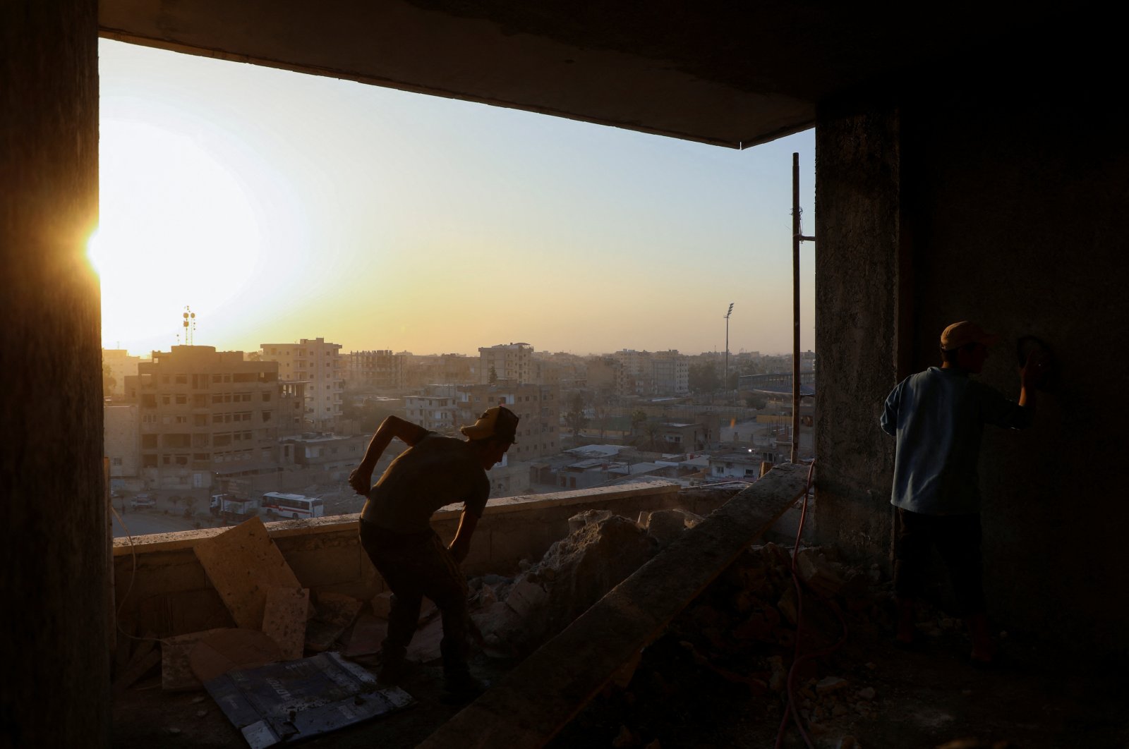 Construction workers labor inside a building in Raqqa, Syria, Oct. 13, 2022. (REUTERS Photo)