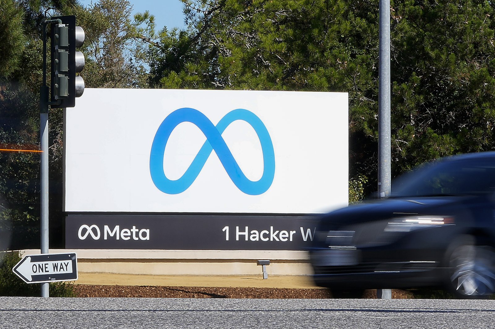 A car passes the Meta logo on a sign at the company headquarters in Menlo Park, California, U.S., Oct. 28, 2021. (AP Photo)
