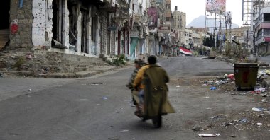Men ride through streets wrecked by fighting in Taiz, Yemen, Feb. 4, 2018. (AP File Photo)