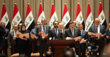 A handout picture released by the Iraqi parliament media office shows Members of the new cabinet taking the constitutional oath during the Iraqi parliament session in Baghdad, Iraq on 27 October 2022. (EPA Photo)