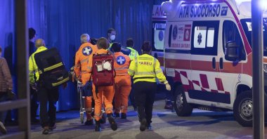 Medics wheel an injured person into an ambulance at the scene of an attack in Milan, Italy, Oct. 27, 2022. (LaPresse via AP)