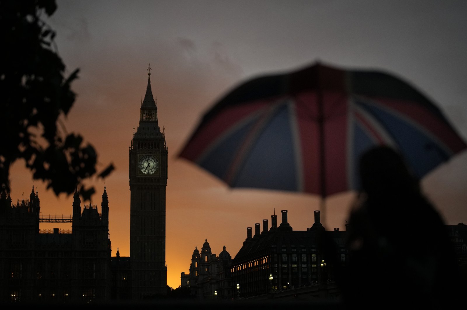 A woman walks past Big Ben as she waits in line to pay respect to the late Queen Elizabeth II at Westminster Hall in London, England, Sept. 18, 2022. (AP Photo)