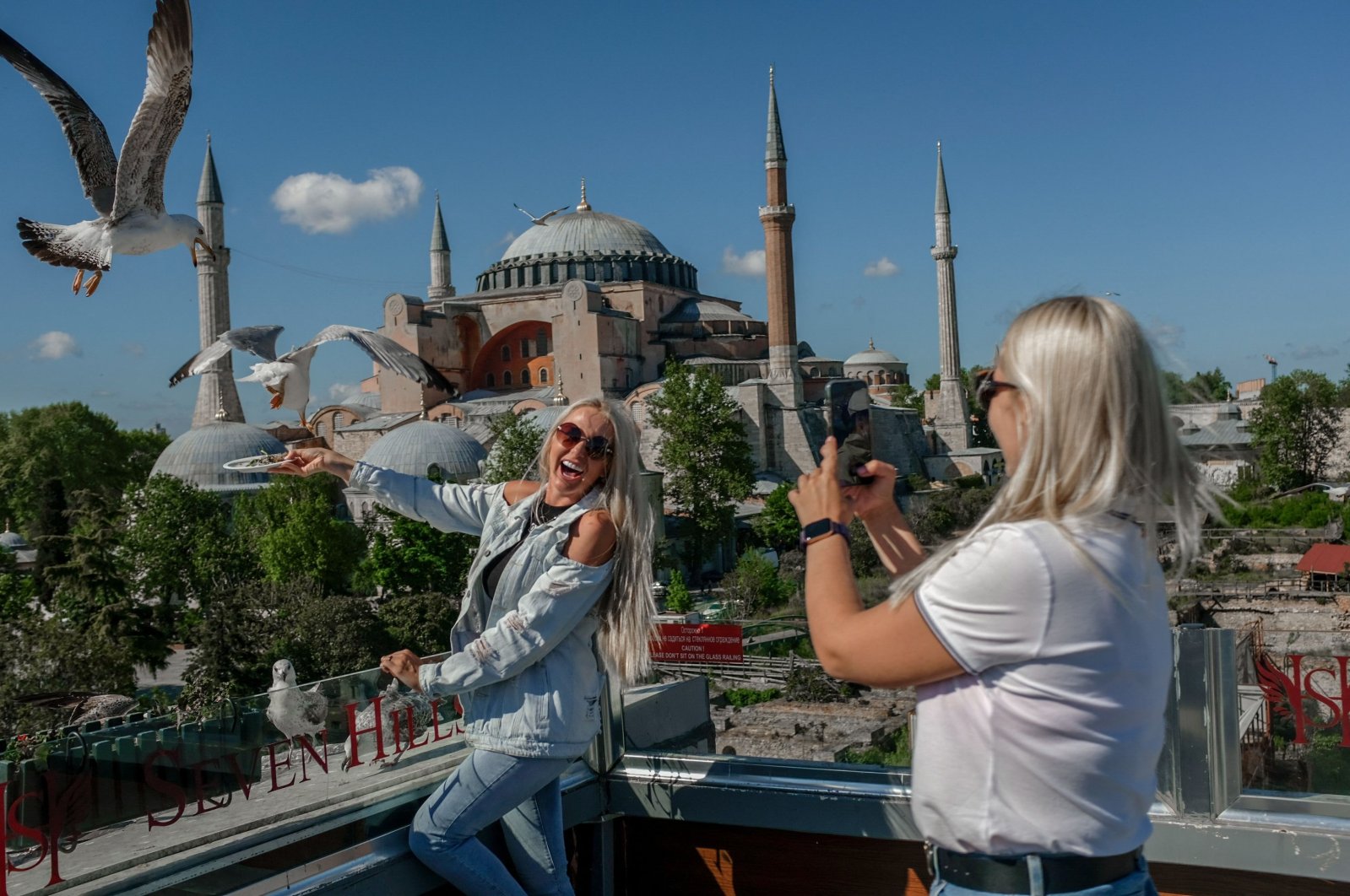A tourist poses for a picture near the Hagia Sophia Grand Mosque in Sultanahmet, Istanbul, Türkiye, May 9, 2021. (AFP Photo)
