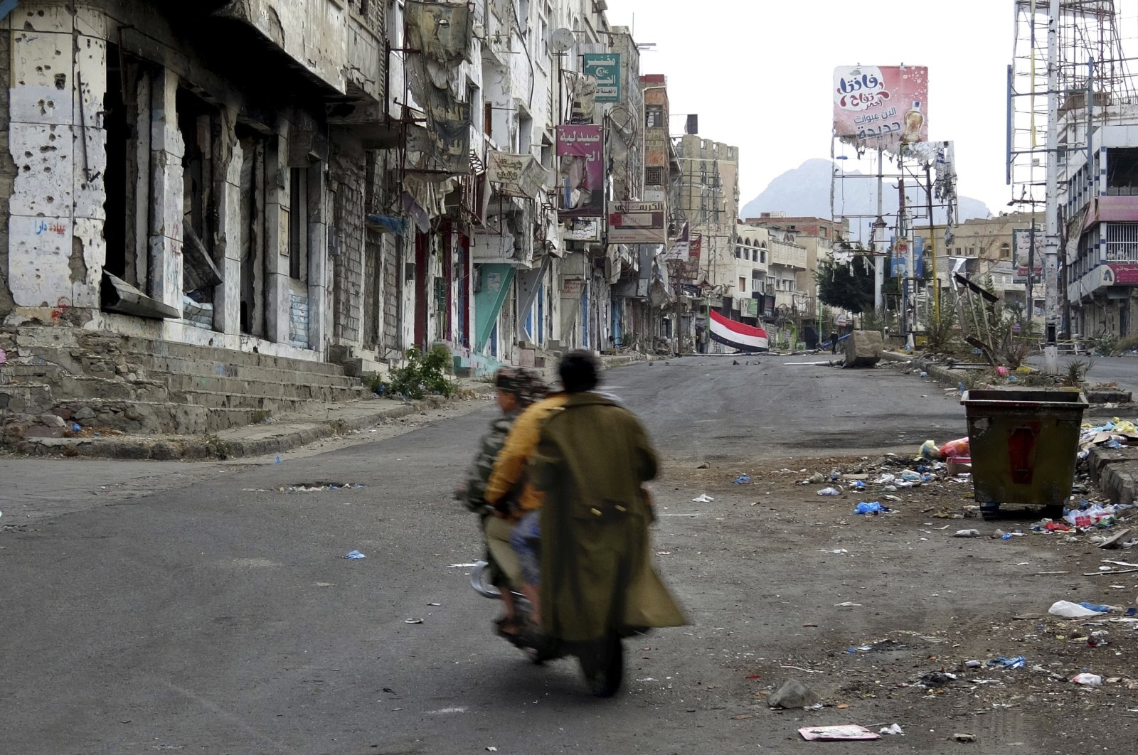 Men ride through streets wrecked by fighting in Taiz, Yemen, Feb. 4, 2018. (AP File Photo)