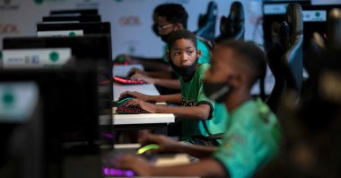 Children play a video game called "League of Legends" during a game tactics class at the NGO AfroReggae headquarters of the Vigario Geral favela in Rio de Janeiro, Brazil, May 14, 2021. (AFP Photo)