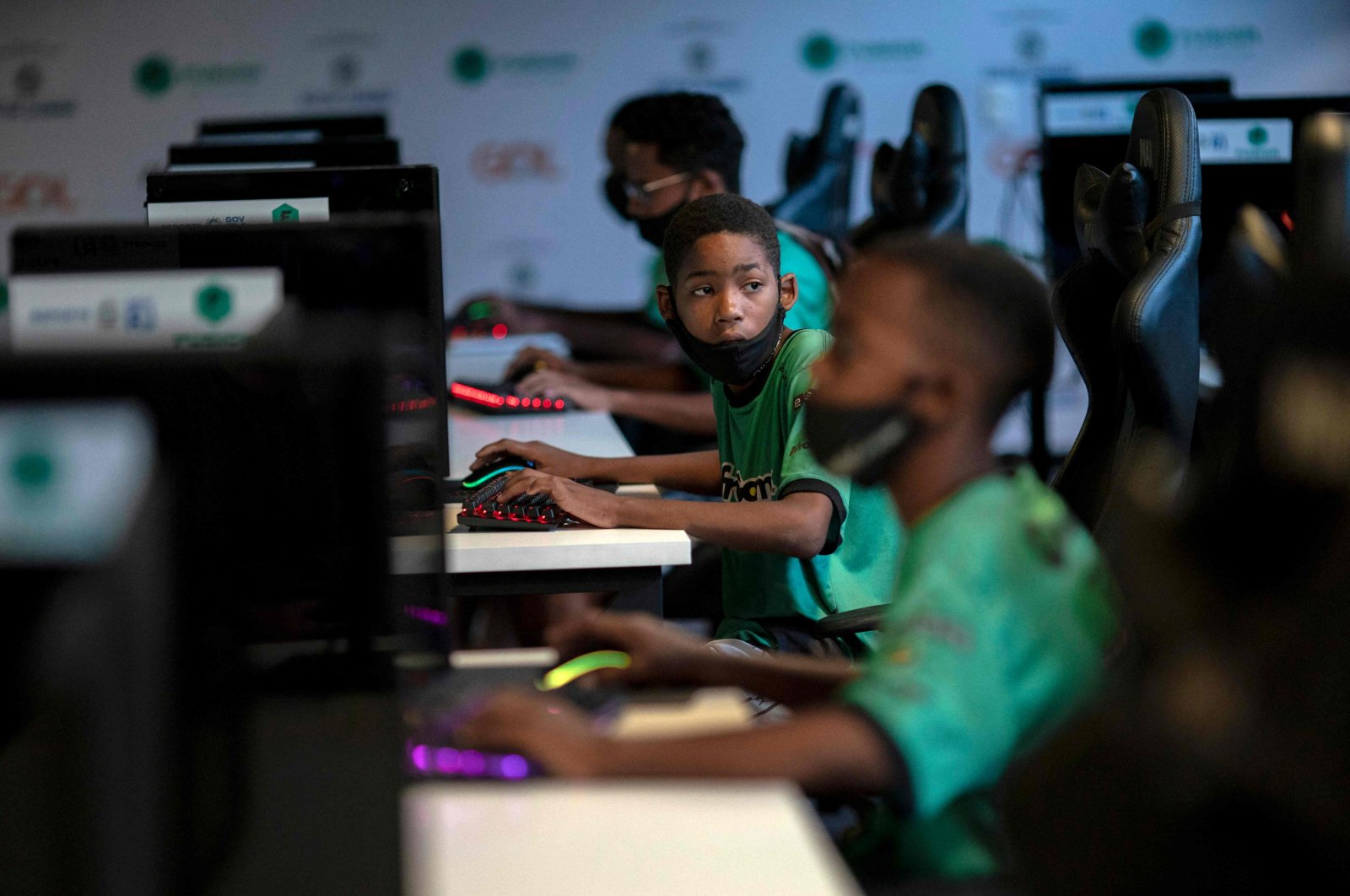 Children play a video game called &quot;League of Legends&quot; during a game tactics class at the NGO AfroReggae headquarters of the Vigario Geral favela in Rio de Janeiro, Brazil, May 14, 2021. (AFP Photo)