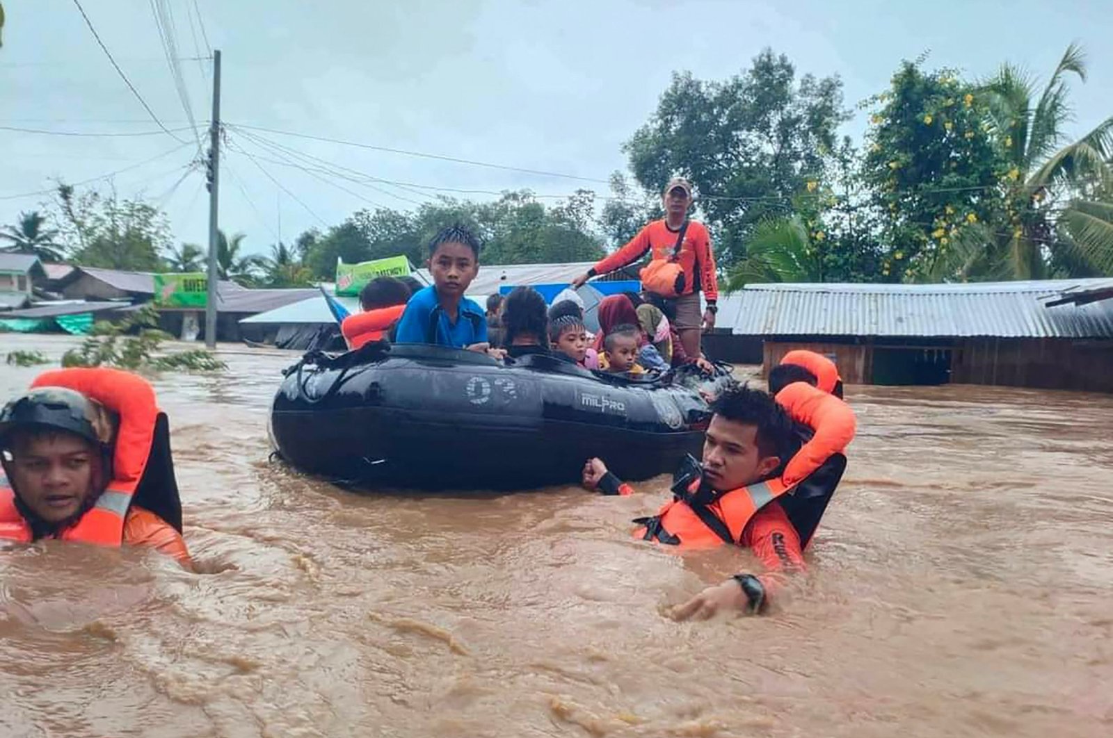 Rescue workers evacuating people from a flooded area due to heavy rain brought by Tropical Storm Nalgae, Parang, Maguindanao province, Philippines, Oct. 28, 2022. (AFP Photo)
