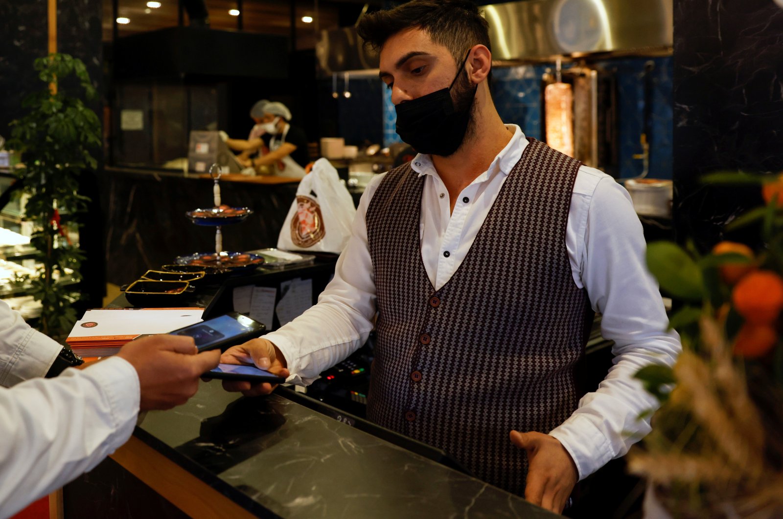 A cashier receives a payment at a restaurant in Istanbul, Türkiye, April 27, 2021. (Reuters Photo)