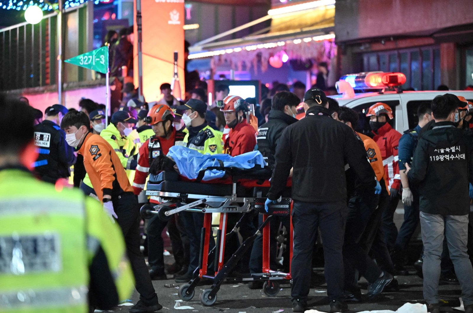 A person, believed to have suffered from cardiac arrest, is transported on a stretcher in the popular nightlife district of Itaewon in Seoul, South Korea, Oct. 30, 2022. (AFP Photo)