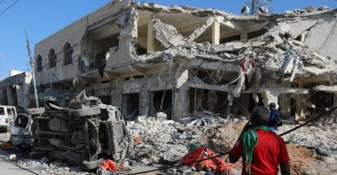 Locals look at the debris from a destroyed building in Mogadishu, Somalia, Oct. 30, 2022. (AFP Photo)
