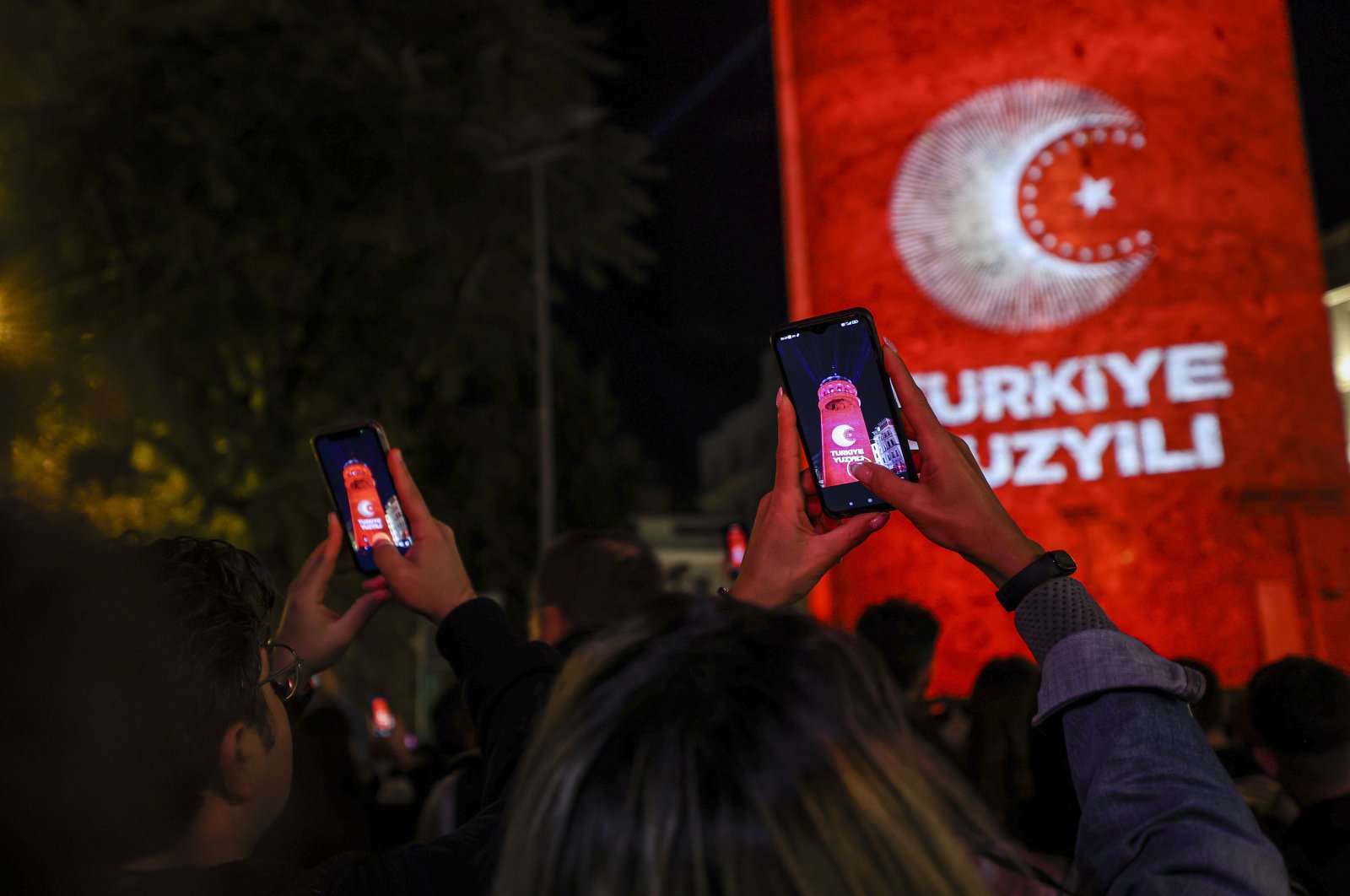 People take photos of a visual presentation reflected on Galata Tower on the occasion of Republic Day celebrations, Istanbul, Türkiye, Oct. 29, 2022. (AA Photo)