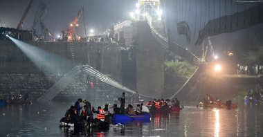 Rescuers conduct search operations after a bridge across the river Machhu collapsed in Morbi, Gujarat, India, Oct. 31, 2022. (AFP Photo)