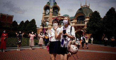 People wearing face masks visit the Shanghai Disney Resort, in Shanghai, China, June 30, 2022. (Reuters Photo)