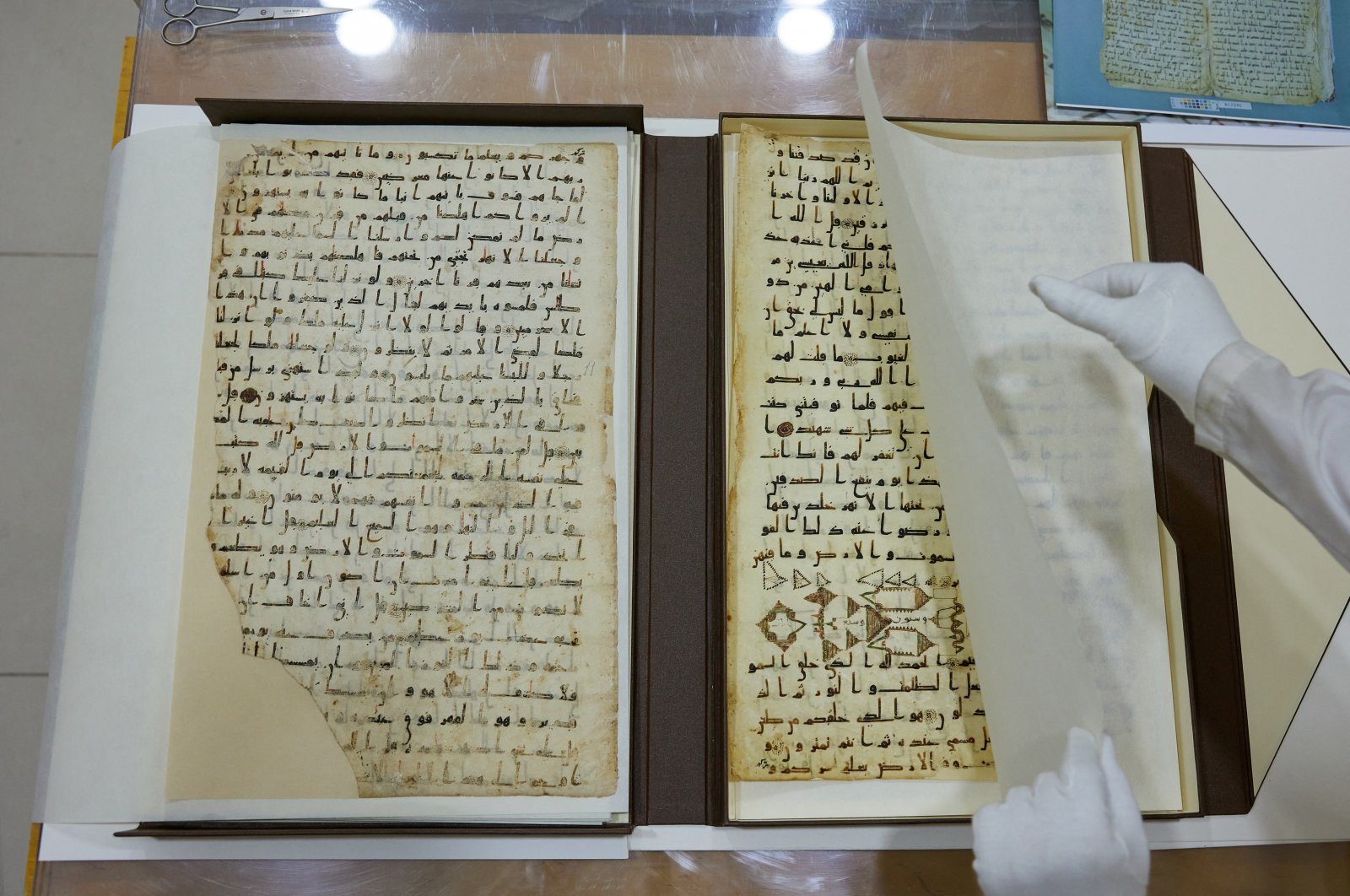 A specialist shows a fragment of the 8th century &quot;Katta Langar&quot; Quran, Samarkand, Uzbekistan, Oct. 21, 2022. (Reuters Photo)