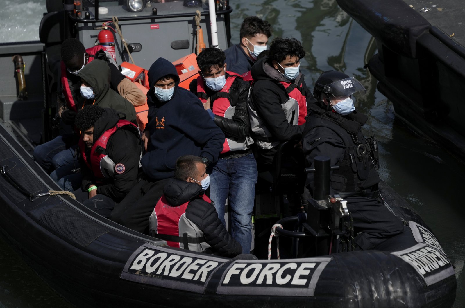 People thought to be migrants arrive to be disembarked in Dover, southeast England, June 17, 2022. (AP Photo)