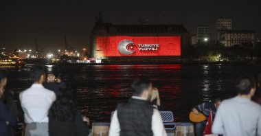 People take a look at a visual presentation reflected on Haydarpaşa Train Station on the occasion of Republic Day celebrations, Istanbul, Türkiye, Oct. 29, 2022. (AA Photo)