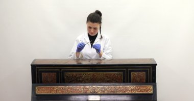 The restorer of the Sedef Atelier workshop of the National Palaces are carrying the cultural heritage of the Ottoman Empire to future generations by restoring the historical pianos in National Palaces, Istanbul, Türkiye, Oct. 13, 2022. (AA Photo)
