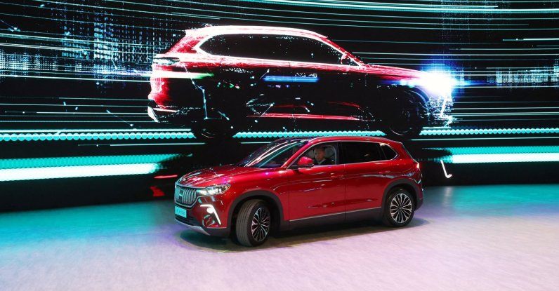 President Recep Tayyip Erdoğan drives a Togg onstage during the opening ceremony of its factory to begin mass production of the country's first domestic vehicle Togg, Gemlik, Türkiye, Oct. 29, 2022. (PPO Handout via Reuters)